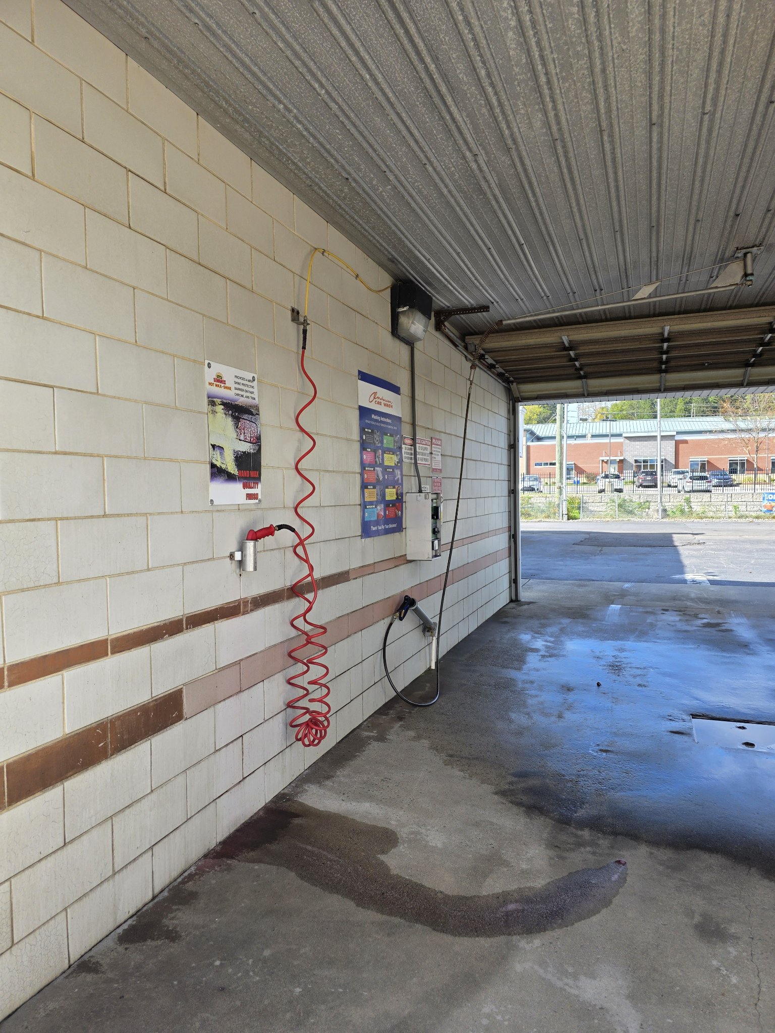 A self-serve wash bay at Anderson Car Wash on Queen Street